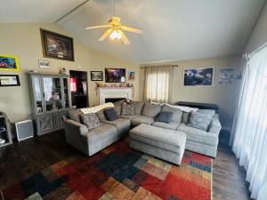 a living room with two couches and a ceiling fan at Be our Guest in Sevierville