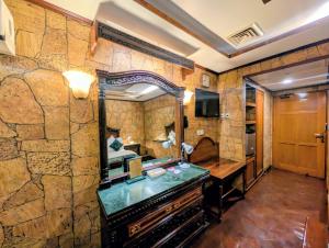 a bathroom with a large mirror and a dresser at Hotel Galaxy in Karachi