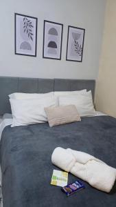 a bed with a blanket and some pictures on the wall at Sao Luis Praia Studio in São Luís +8 photos