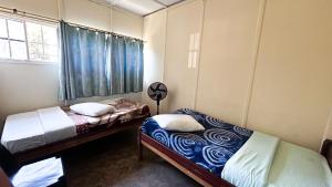 a bedroom with two beds and a window at Crystal Hostels in Livingstone +11 photos