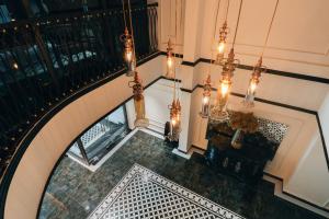 an overhead view of a staircase with a chandelier at Selah Hanoi Hotel in Hanoi