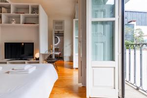 a bedroom with a bed and a sliding glass door at Mouzinho 226 in Porto