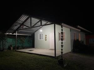 a large white building with a garage at night at Casa Colibrí Volcán in Volcán