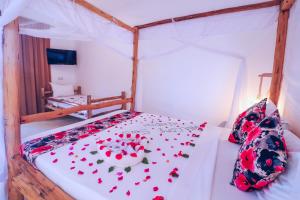 a bedroom with a bed with red hearts on it at Sansi Kendwa Beach Resort in Kendwa