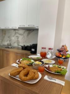 a table with onion rings and other food on it at Guest House Nuhellari 2 in Çorovodë
