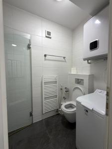 a white bathroom with a toilet and a sink at Panamera Luxury Apartment Ilidža in Sarajevo +8 photos
