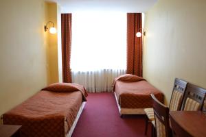 a hotel room with two beds and a window at Noclegi Sezam in Łańcut