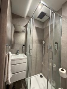 a bathroom with a shower and a sink at Mabledon Court Hotel in London
