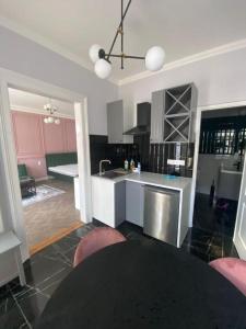 a kitchen with a table in the middle of a room at Cozy Modern Studio in Debrecen