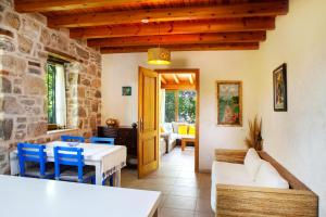 a living room with a table and blue chairs at Villa Limon by Important Group Travel in Bitez