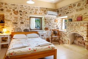 a bedroom with a bed and a stone wall at Villa Limon by Important Group Travel in Bitez +61 photos