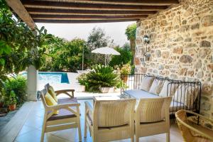 a patio with a table and chairs and a pool at Villa Limon by Important Group Travel in Bitez