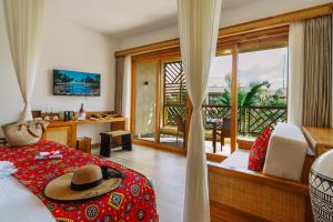 a bedroom with a bed with a hat on it at Anaya Hotel Zanzibar in Pwani Mchangani