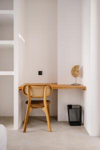 a wooden desk in a room with a chair at FinnKai Villas in Sengkol