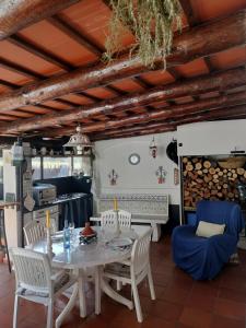 a kitchen and dining room with a table and chairs at El Patio in Darnius