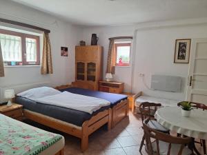 a bedroom with a bed and a table and chairs at Flamingo Apartman in Sopron +15 photos
