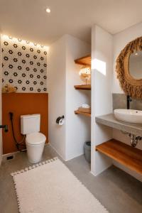 a bathroom with a toilet and a sink at FinnKai Villas in Sengkol +24 photos