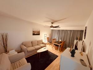 a living room with a couch and a table at 3-Room Apartment Up to 5 Guests Family Business Free WiFi Netflix Sky DAZN Disney Plus 1000 International TV Channels in Wynau