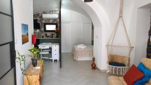 a room with a desk and a bedroom with a bed at Mirador in Beja
