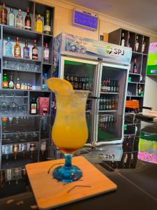 a drink in a glass on a counter in a bar at Ravens nests lodge in Livingstone