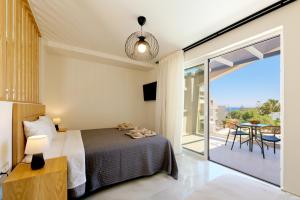a bedroom with a bed and a balcony at Jechrina in Kato Daratso +74 photos