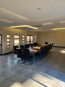 a large conference room with a long table and chairs at Ravens nests lodge in Livingstone +24 photos