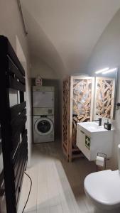 a bathroom with a sink and a washing machine at Mirador in Beja