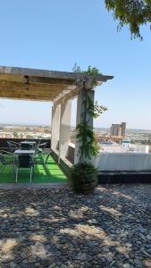 a patio with a table and chairs on a roof at Mirador in Beja