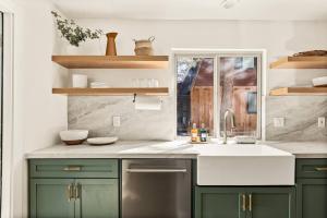 a kitchen with green cabinets and a sink at Modern Hideaway in Big Bear in Big Bear City +27 photos