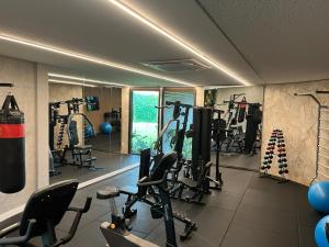 a gym with several tread machines in a room at Refúgio Azul de Porto in Porto De Galinhas