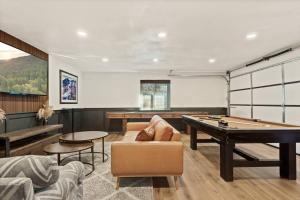 a living room with a pool table and a couch at Modern Hideaway in Big Bear in Big Bear City