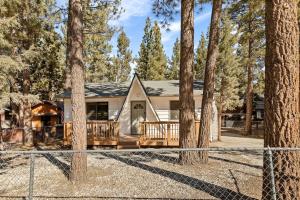 a house in the woods with a fence at Modern Hideaway in Big Bear in Big Bear City