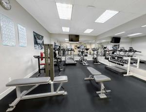 a gym with a lot of treadmills and machines at Coast Abbotsford Hotel & Suites in Abbotsford