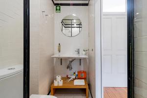 a bathroom with a sink and a mirror at Mouzinho 226 in Porto +91 photos