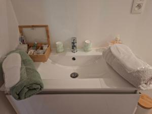 a bathroom sink with towels and a mirror at Au doux Chardon in Durbuy +93 photos