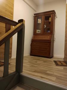 a staircase with a wooden dresser in a room at Horstis Fewo Apartment Reni in Frankenhain +12 photos
