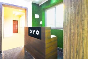 an office with aype sign in a room with green walls at Hotel O Grand 55 in Bālianta