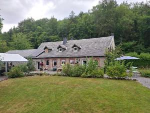a large house with a yard in front of it at Au doux Chardon in Durbuy