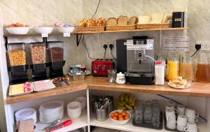 a shelf with a coffee maker and some food at Edinburgh full bliss in Edinburgh