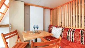 a room with a table and chairs and a couch at Mini Stylish - Central Studio w kitchen in Himare