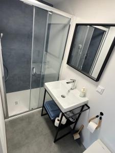 a bathroom with a sink and a shower at Piankowe mini-apart in Rewal