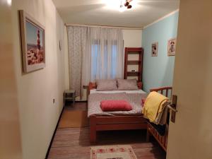 a small bedroom with a bed and a window at Dečiji vinogradi Belgrade, Sopot, Kosmaj in Sopot +145 photos