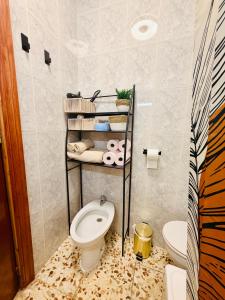 a bathroom with a toilet and a sink at Cala de Los Lobos in Puerto de Mazarrón +6 photos