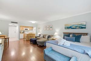 a bedroom with a large bed and a living room at 2479 Shipwatch in Kiawah Island