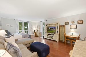 a living room with a couch and a tv at 2479 Shipwatch in Kiawah Island +33 photos
