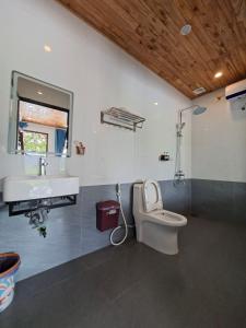 a bathroom with a white toilet and a sink at Vivian riverside cottage - Ninh Bình in Nguyên Ngoại +44 photos