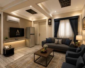 a living room with a couch and a refrigerator at El Amin Hotel & Suites - Downtown Cairo in Cairo