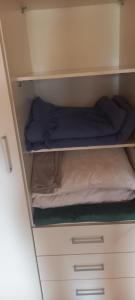 a cupboard with a bed on top of it at Mysan in Glommersträsk