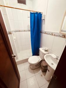a small bathroom with a toilet and a sink at Estancia 3 in Tena