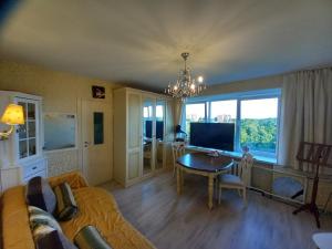 a living room with a couch and a table at Amber Beach Apartment in Narva-Jõesuu